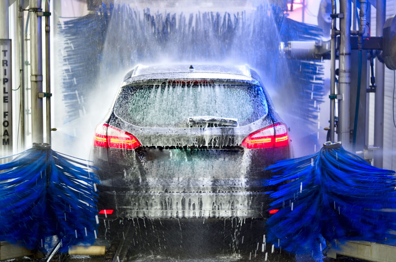 Self service car wash applying soap to a car.