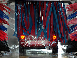 Soft cloth car wash cleaning a car